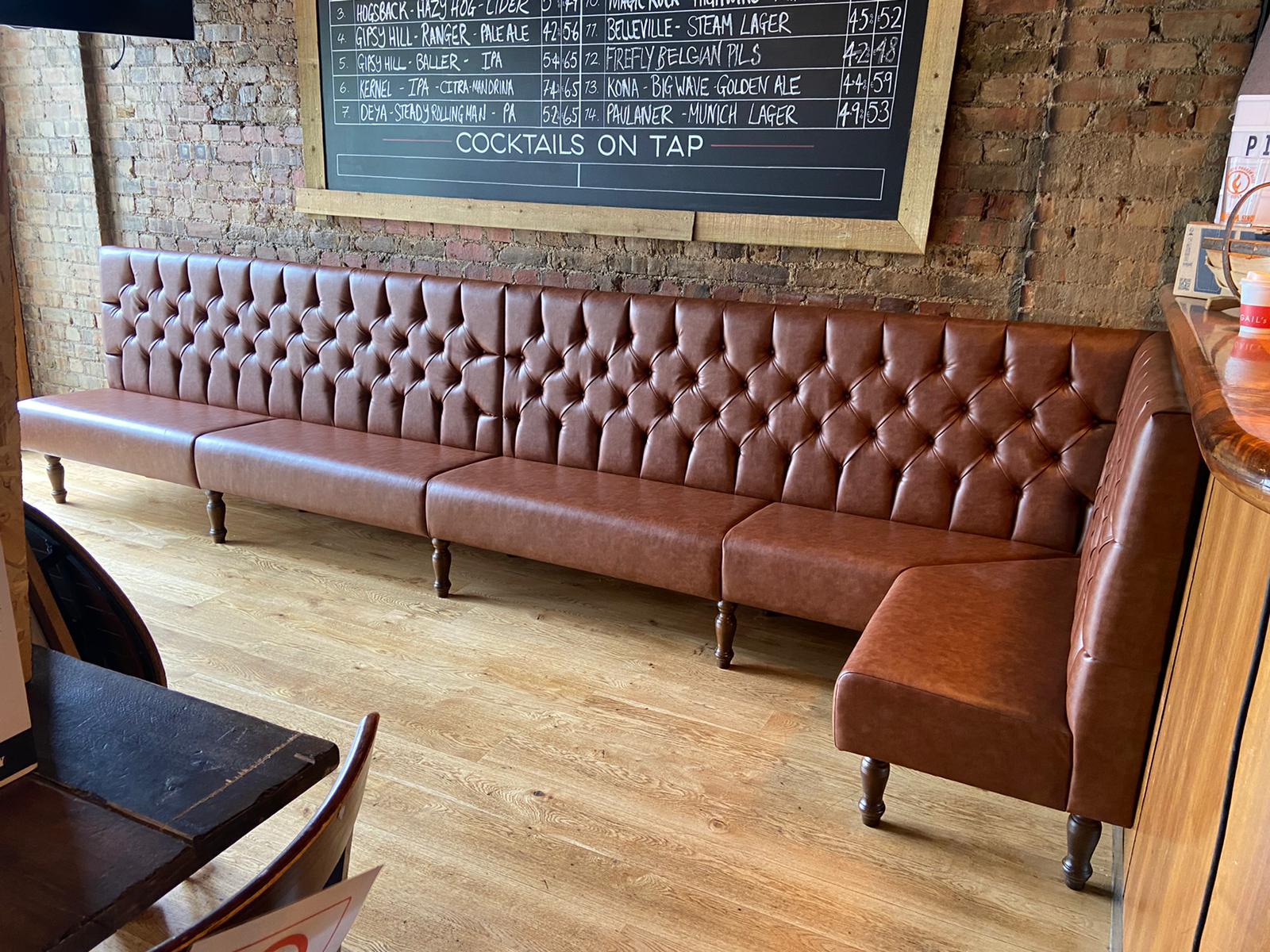 Deep buttoned seating with turned legs